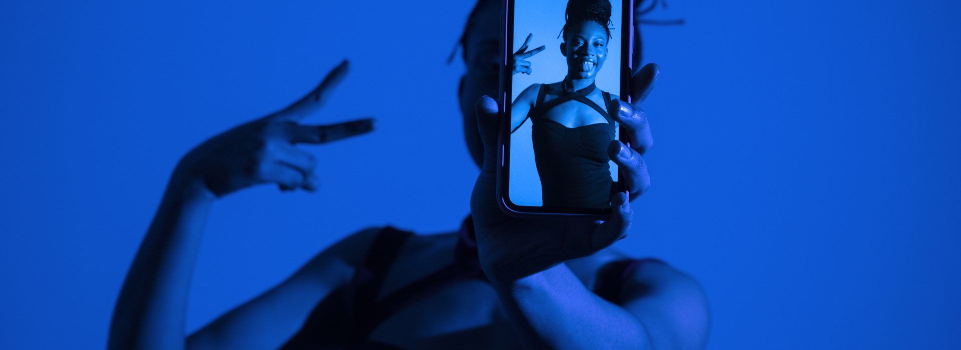 medium-shot-woman-holding-smartphone